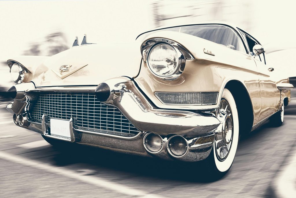 A classic Cadillac captured in motion, showcasing its vintage charm and sleek design.